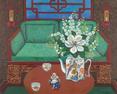 A beautiful orienat sofa with jade cushions and a beautiful teapot filled withflowers , a magnolia and blossoms